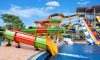 Swimming pool with water slides on sunny day